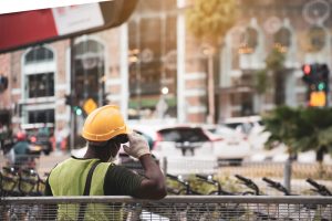 A migrant construction worker resting by the side of the road in Singapore